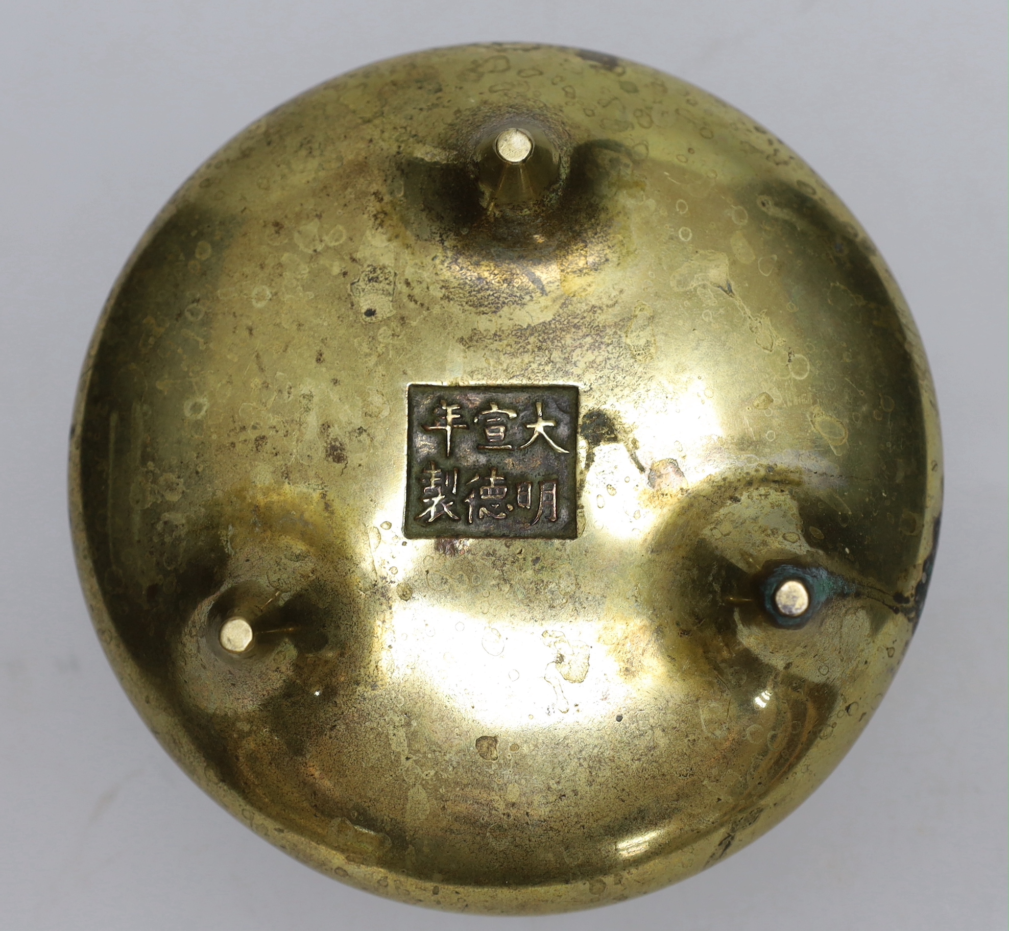 A late 19th century Chinese bronze censer with twin handles, apocryphal Xuande mark, 17.5cm in diameter
